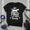 MY Pitbull IS MY RUNNING Buddy text with a running pitbull graphic and paw prints on a black t-shirt
