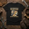 T-shirt design featuring text "NEVER UNDERESTIMATE AN OLD MAN WITH A PIT BULL" above a man and a pit bull