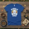 Blue t-shirt with "Pibble Dad" text and a pitbull head graphic with a bone