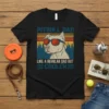 Pitbull Dad Like A Regular Dad But Cooler text with a pitbull wearing sunglasses graphic on a black t-shirt