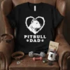 Black t-shirt with white "PITBULL DAD" text and a heart graphic featuring a pitbull dog's head