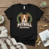 Black t-shirt with "Pitbull Grandma" text in bold white and brown, featuring a pitbull dog portrait framed by a laurel