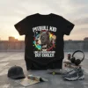 Pitbull Kid Like A Regular Kid But Cooler text on black t-shirt with illustrated pitbull wearing a hat and collar
