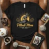 Pitbull Mom EST. 2024 t-shirt design featuring a pitbull silhouette on a mountain peak with a sunburst and paw prints