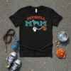 Pitbull Mom t-shirt with retro font, silhouette of a pitbull, and a fist holding a leash with a paw print