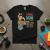Pitbull Mom Tattoos With Pretty Eyes And Thick Thighs text design on a black t-shirt, featuring a tattooed woman and