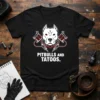 Black t-shirt with white text "PITBULLS AND TATOS." featuring a pitbull head graphic and tattoo machines