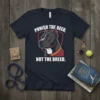 Navy t-shirt with bold white text "PUNISH THE DEED, NOT THE BREED." featuring a graphic of a pitbull's head inside
