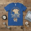 Blue t-shirt featuring "Rescue The Mistreated Save The Injured Love The Abandoned" text with dog graphic and hands holding paw