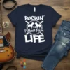 ROCKIN' THE Pitbull Mom LIFE text with two pitbulls and guitars graphic on a navy t-shirt