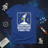 Sometimes Motivation Finds You quote on a blue t-shirt with a rocket ship launching into a starry night sky