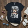 Sorry I'm Late My Pitbull Was Sitting On Me T-Shirt with a cartoon pitbull graphic