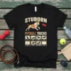 Stubborn Pitbull Tricks t-shirt design featuring a pitbull playing frisbee and illustrations of various dog tricks like sit, down, shake