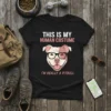 Black t-shirt with "THIS IS MY HUMAN COSTUME I'M REALLY A PITBULL" text and a pitbull wearing glasses graphic