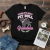 Black t-shirt with "World's Best Pit Bull Grandma" text and a pit bull graphic, pink heart, and floral accents
